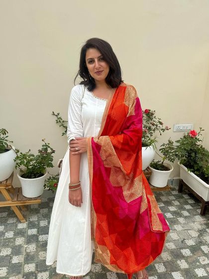 A classic pose showing the beautiful contrast of the white kurta and colorful dupatta.