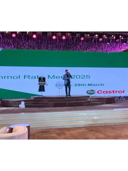 A wide shot of the stage for the Castrol "Anmol Ratn Meet 2025," showing the professional setup and large screen integration for my performance.