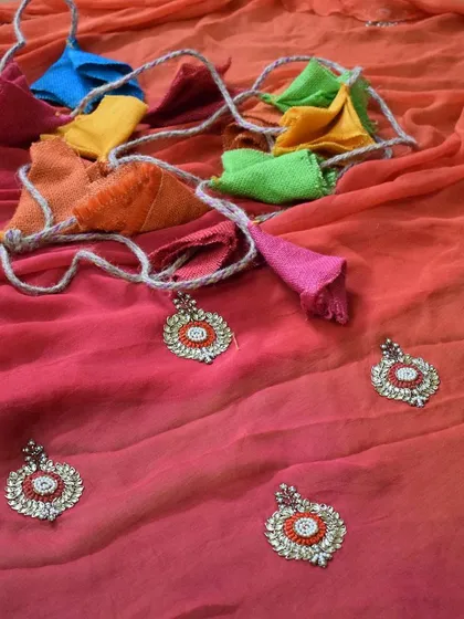 This ombre-dyed saree in shades of pink and orange is embellished with delicate Kundan work motifs. I believe in enhancing the beauty of a saree with details that catch the light and the eye.