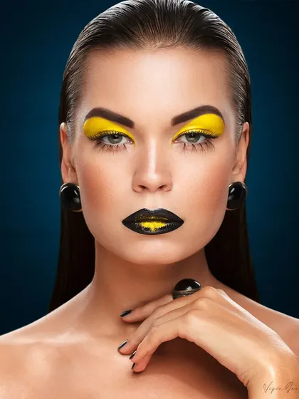 Beauty photography allows for creative expression. This shot combines bold, high contrast makeup with precise lighting and slicked back hair to create a striking, high fashion look perfect for a beauty campaign.