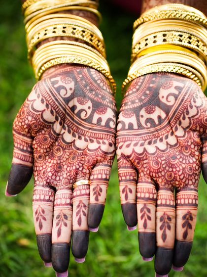 A close-up of the palms, showing the dark stain and the adorable elephant motifs.