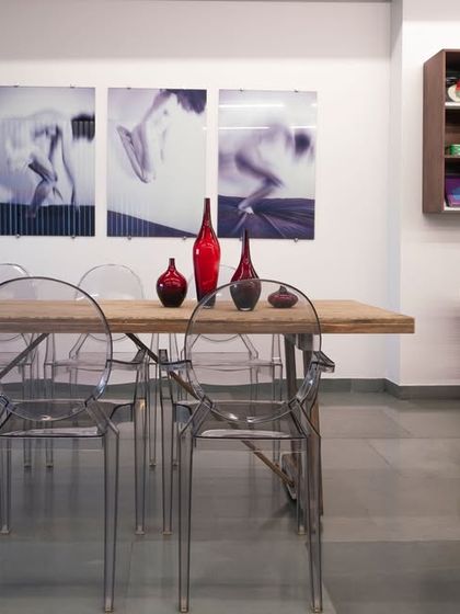 A view of the conference table in the Ecstacy showroom, which seamlessly merges with the display area. This design blurs the lines between a workspace and a showcase of Italian garments.