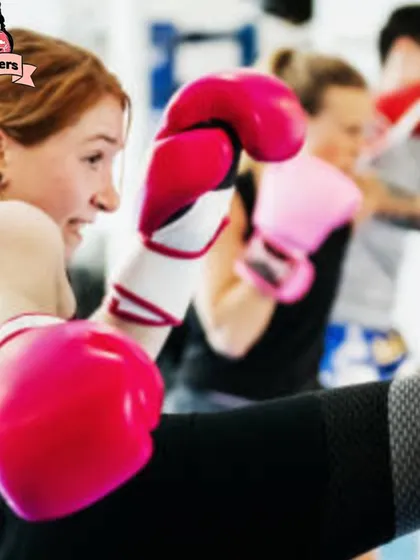 A group of women engaged in a high-energy kickboxing class. The focus is on technique, power, and mutual motivation.