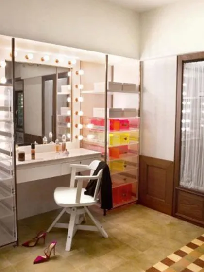 A functional and glamorous dressing area designed for Alia Bhatt. The vanity with classic makeup lights and colorful acrylic drawers is both practical and playful, creating a space that is perfectly organized for a busy actor.