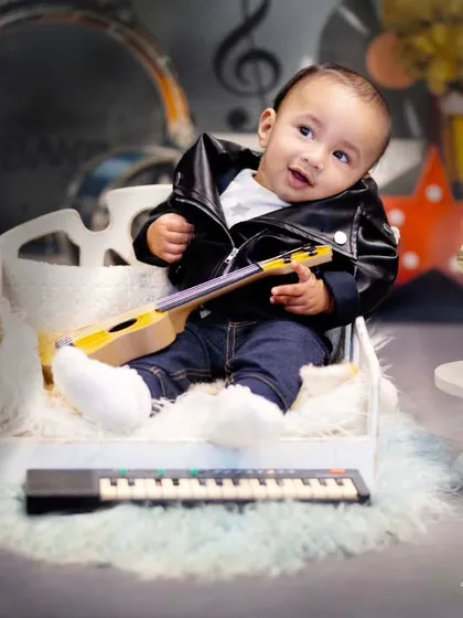 My little stud boy and model. This five-month-old is rocking a leather jacket and a tiny guitar in this cool musical-themed photoshoot.
