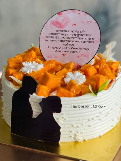 A personalized Chocolate Mango Cake for a 15th wedding anniversary. The silhouette topper adds a romantic touch to this delicious seasonal cake.