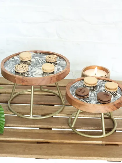 Both sizes of our Moon Ray stands with the leaf print, styled with macarons and a candle. This showcases how beautifully they can be layered to create a dynamic dessert display.