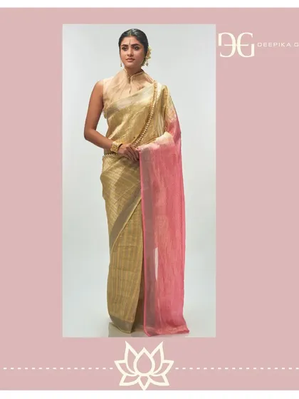 As part of 'The Bride's Treasure', this opulent tissue jacquard saree is designed for life's most cherished moments. The pale yellow body is gracefully complemented by a rose-colored pallu, blending traditional weaving techniques with a contemporary color palette.