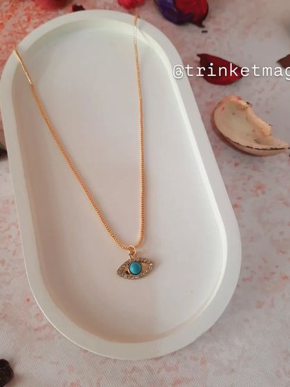 A simple and elegant necklace featuring a turquoise evil eye charm on a delicate gold chain. It's a timeless piece for everyday protection.