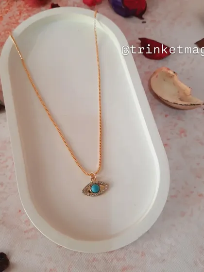 A simple and elegant necklace featuring a turquoise evil eye charm on a delicate gold chain. It's a timeless piece for everyday protection.