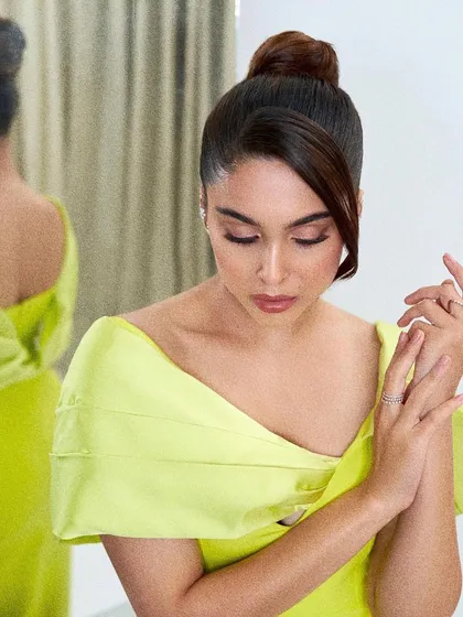 A close-up of the Safiyaa gown, showing the clean lines, beautiful fabric, and the chic top-knot hairstyle it was paired with.