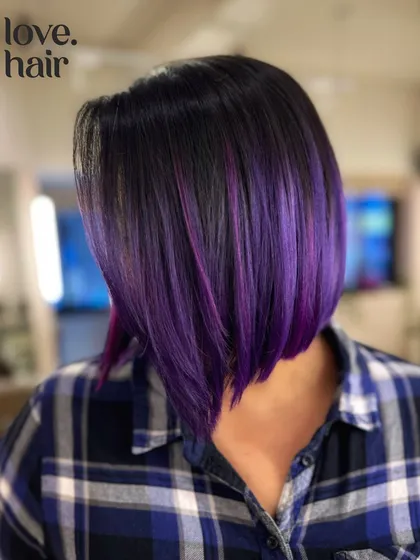 Another angle of the purple angled bob, showing off the clean lines and bold color.