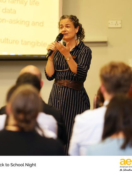 A middle school teacher explains her curriculum to an engaged audience of parents. Thank you to all our families for partnering with us to support our students.