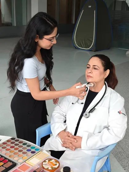 Here I am on set for a corporate shoot with Medanta Hospital, providing camera-ready makeup for one of the doctors. My on-set process is efficient and professional, ensuring everyone looks their best without causing delays to the production schedule.