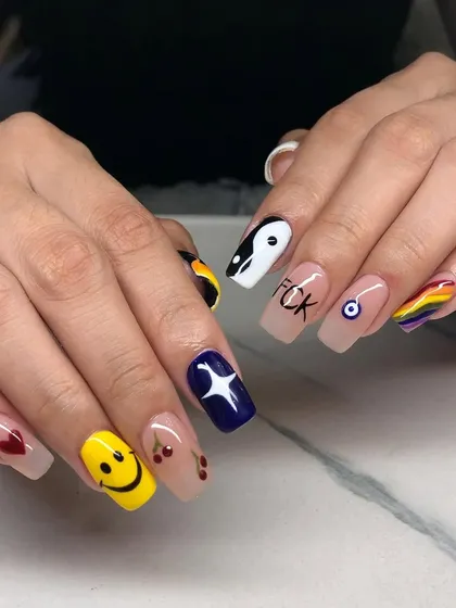 Let your nails show your fun side. This set of square nail extensions features a different quirky design on each finger, including a smiley face, cherries, a yin-yang symbol, and a rainbow.