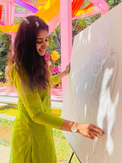 Here I am, sketching the initial portrait onto the canvas before the guests add their colorful touches.