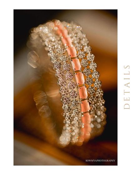 A macro shot of a stunning bridal bracelet with diamonds and pink stones. The bokeh in the background makes the jewelry pop.