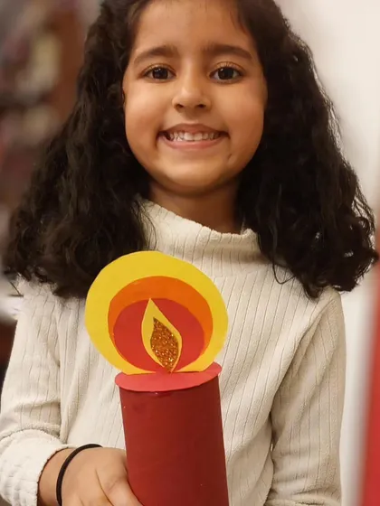 The joy on her face says it all! She is so happy with the Christmas candle she made.