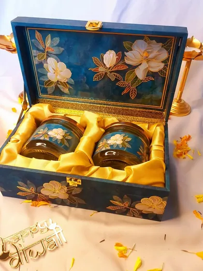 This hand-painted wooden box with matching jars is a perfect example of our luxury Diwali collection. It combines traditional artistry with practical use, creating a gift that will be cherished.