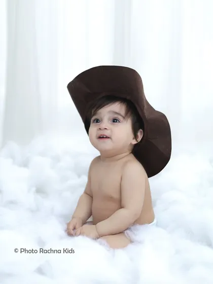 A simple and sweet portrait from the celestial shoot, with the toddler wearing a cowboy hat amidst the clouds.