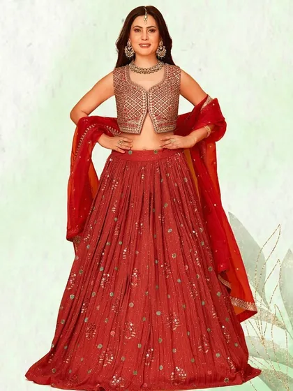 Find the perfect attire for your wedding season. This red lehenga with a jacket-style blouse offers a unique silhouette for any bridal event.