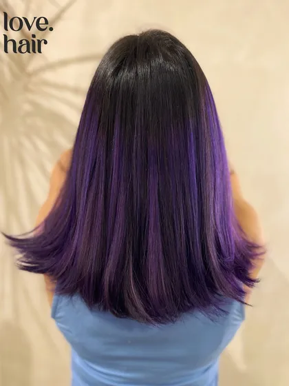 The same purple balayage, styled straight to show the placement of the color panels.