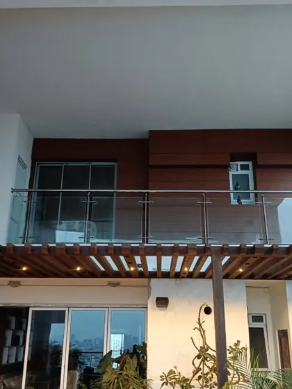 A recently completed project showing our wood-look cladding on the balcony wall, paired with a glass railing and a pergola structure below. We ensure all exterior elements work together seamlessly.