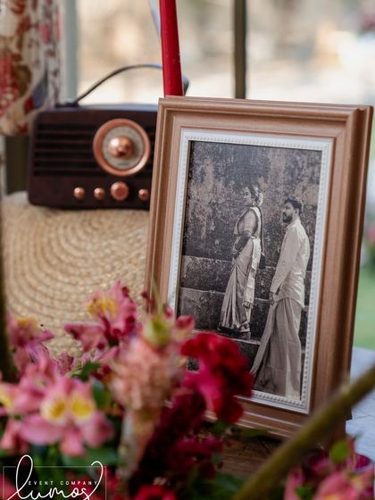 A detail shot from a regal wedding, with a vintage radio and a framed black and white photo.
