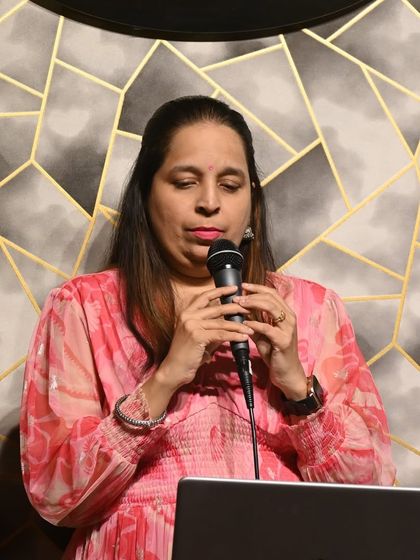 A student practicing her song during a karaoke session. Our studio provides a professional setup for students to hone their performance skills.