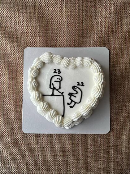 A heart-shaped bento cake with a funny Flork meme design, perfect for celebrating a 23rd birthday. This one was a vanilla sponge with mixed berry jam.