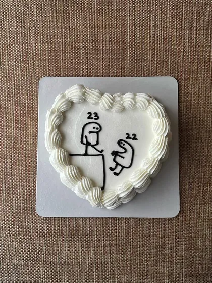 A heart-shaped bento cake with a funny Flork meme design, perfect for celebrating a 23rd birthday. This one was a vanilla sponge with mixed berry jam.