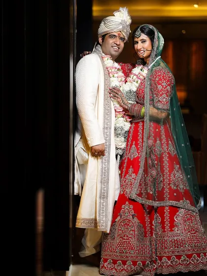 A classic portrait of the bride and groom, showcasing the beautiful details of their wedding outfits and the joy of the occasion.