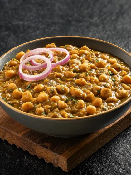 Pindi Chole, a classic North Indian chickpea curry. The dark, rustic styling emphasizes the rich spices and texture of the dish.
