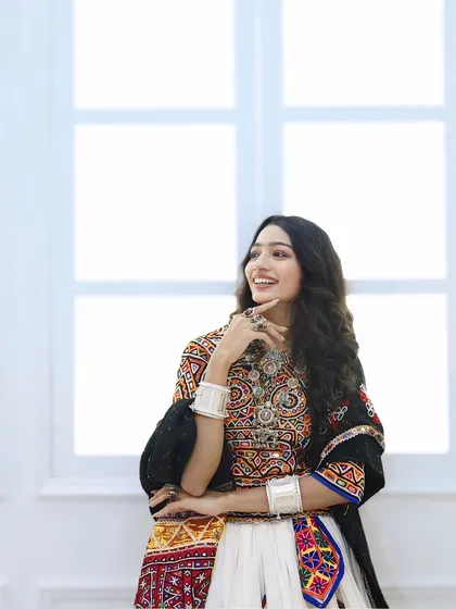 A candid moment of joy. Her Navratri makeup is subtle, with a focus on flawless skin, allowing her happy expression and beautiful outfit to take center stage.