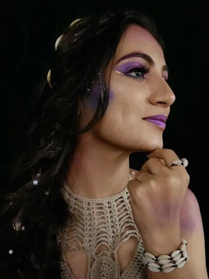 A profile shot that gives a clear view of the scale texture created with an airbrush and stencil, a key technique for this fantasy mermaid makeup.