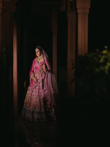 Another dramatic, low-light shot of the bride. This captures the regal and timeless feel of her wedding look.