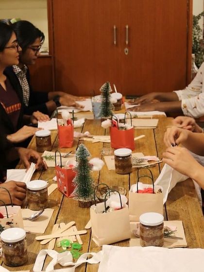 Participants deeply engaged in the tie-dyeing process during our holiday workshop. These sessions provide a great opportunity to unwind and learn a new skill together.
