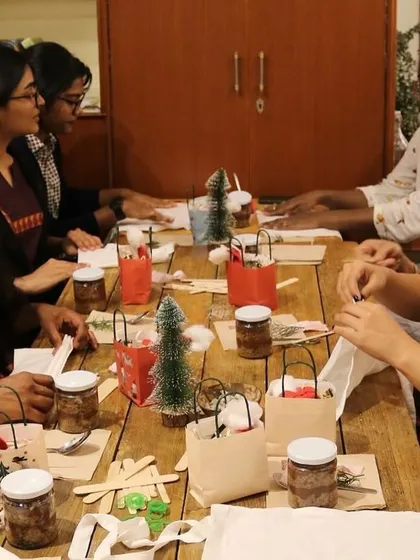 Participants deeply engaged in the tie-dyeing process during our holiday workshop. These sessions provide a great opportunity to unwind and learn a new skill together.