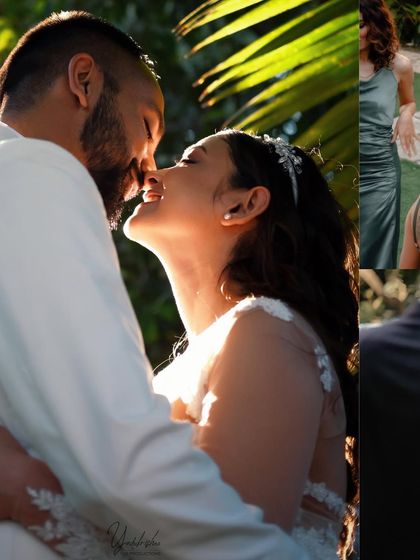 A romantic close-up of a couple sharing a kiss in the golden hour light. The sun filtering through the palm leaves creates a beautiful, dreamy effect.
