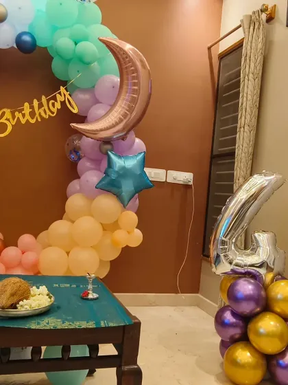 Another angle of the moon and stars themed home decor, showing the number '4' balloon pillar.