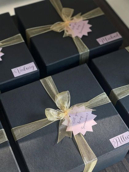 Let's not forget the groomsmen! This sleek black box is the perfect way to thank them. It includes miniatures of Glenlivet and Chivas Regal, a shot glass, a custom hip flask, and a personalized scented candle.