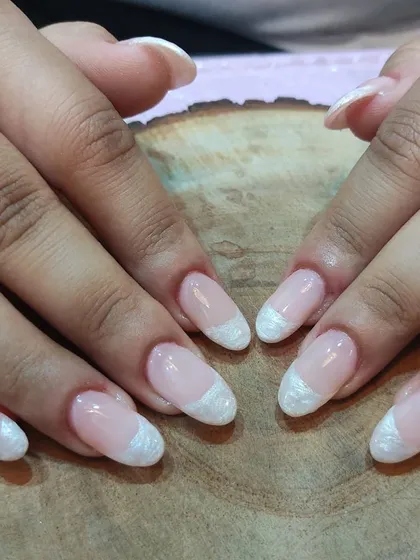 A new way to do French. This design features a textured, pearlescent white tip that gives the classic manicure a unique and modern feel.