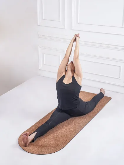 Another perspective of Hanumanasana, with arms raised. This variation adds a heart-opening element to the deep hamstring and hip-flexor stretch.