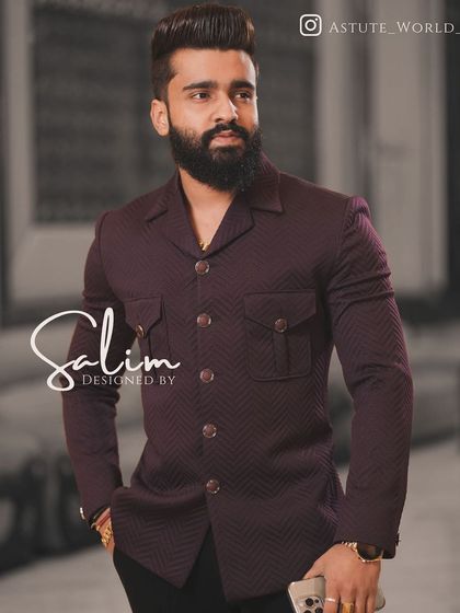A client wearing a maroon Jodhpuri-style jacket with a subtle texture. This is a sophisticated piece that pairs well with black trousers for a modern look.