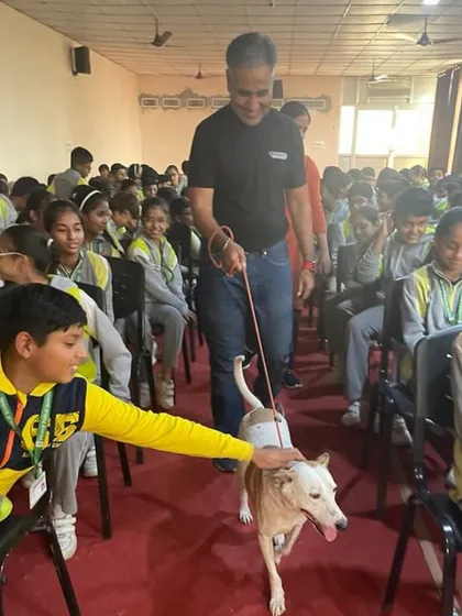 Our founder's rescue dog, Rocky, now works as a therapy dog. Here he is visiting a school, helping children learn about kindness and compassion towards animals.