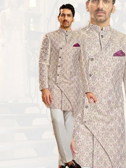 An asymmetrical cut gives this patterned sherwani a modern edge. We designed this for the groom who seeks a balance between timeless patterns and a contemporary silhouette.