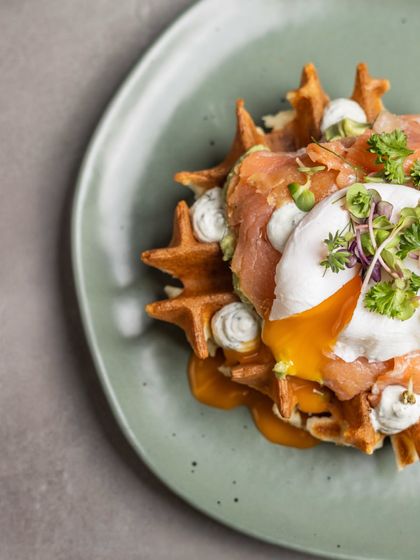 The finished Smoked Salmon Waffle, a beautiful combination of sweet and savory with a runny egg yolk bringing it all together.