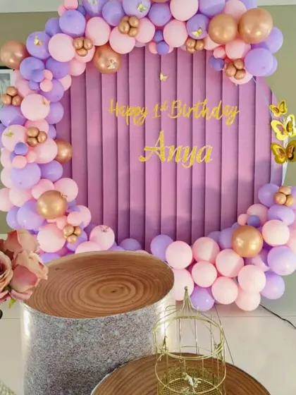 Another angle of Anya's party, showing the textured cake stands and floral arrangements.