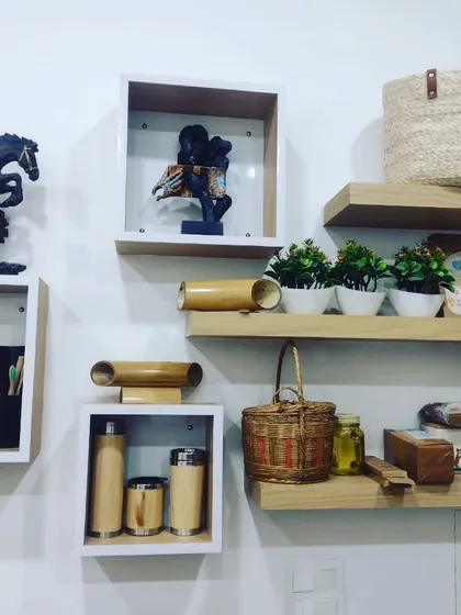 A well-styled shelf display featuring a variety of our sustainable products. It includes bamboo flasks, woven baskets, and other eco-friendly decor, showing how our items can be mixed and matched to create a beautiful, green home.