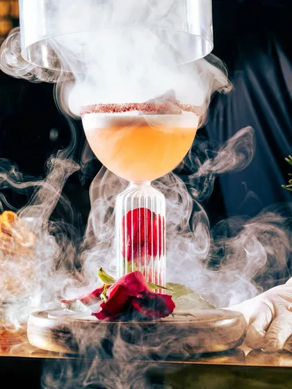 Our cocktails are a performance in themselves. This smoky, charismatic creation, finished with a flourish, is a liquid love letter, perfectly crafted to mark a special celebration or to simply indulge your senses.
